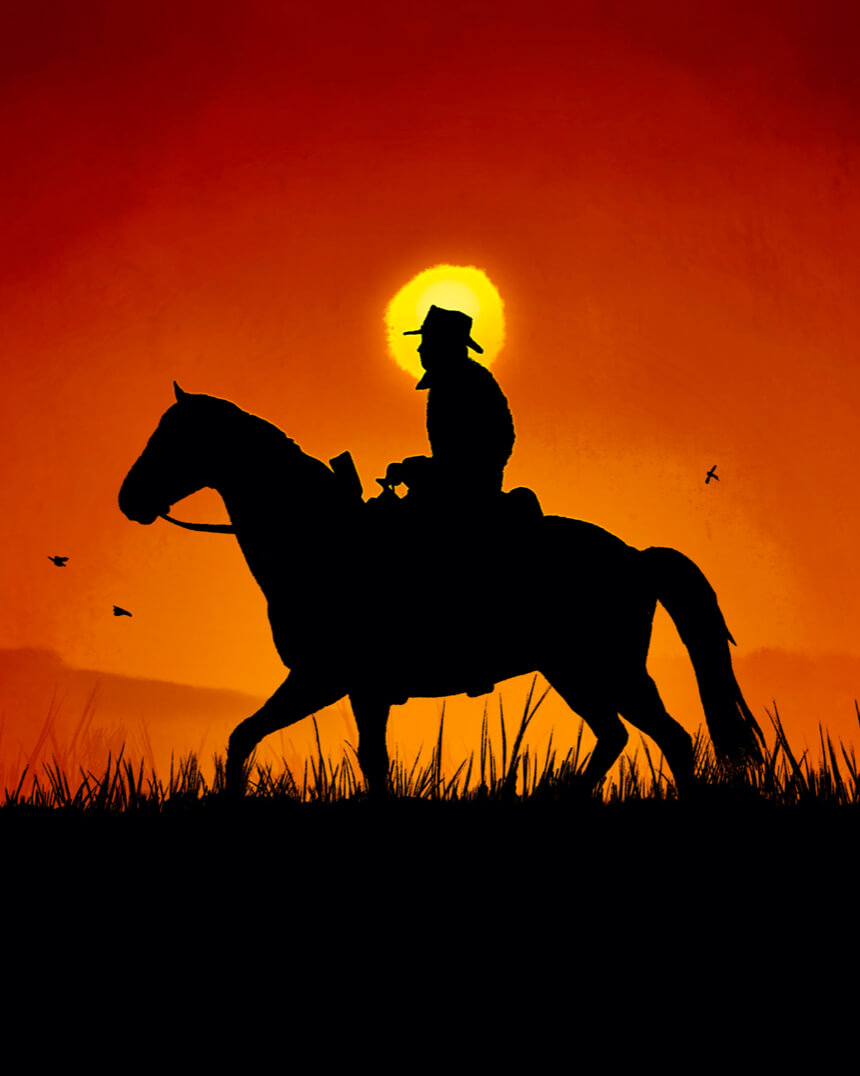 Cowboy riding a horse at sunset.